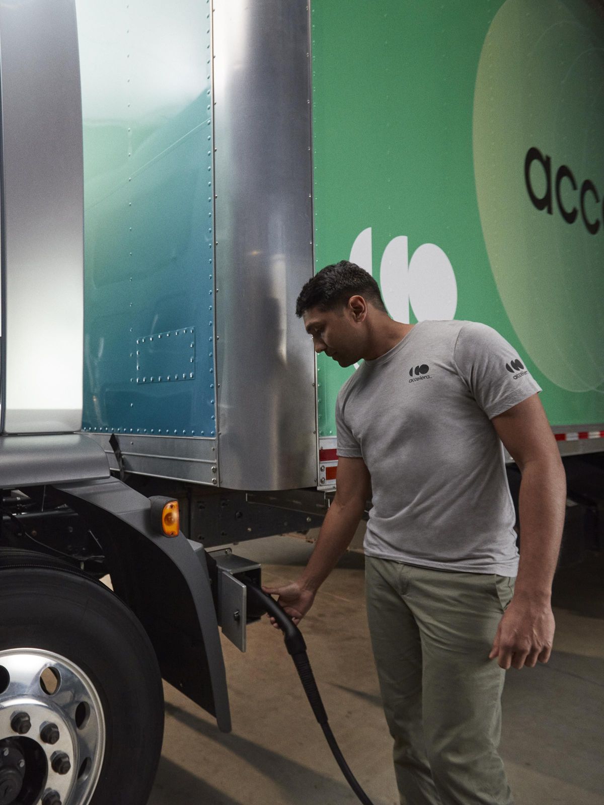 Accelera Technician charging an Accelera zero-emission truck.jpeg